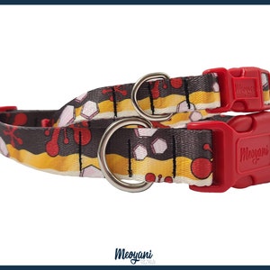 May include: Two dog collars with a colorful pattern of red, yellow, and white shapes on a dark gray background. Each collar has a red plastic buckle and a silver metal ring. The brand name "Meoyani" is printed on the buckle.
