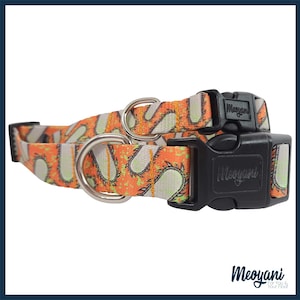 May include: Two dog collars with a repeating pattern of orange and green chainsaw graphics on a light gray background. The collars have black plastic buckles and silver metal D-rings. The brand name "Meoyani" is printed on the buckle.