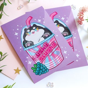 May include: Two purple cards with a black and white cartoon husky in a pink and blue slushie cup. The text on the cup says "Husky Slushie" and "Get Rad, Bro!" The cards are decorated with stars and a cluster of purple grapes.