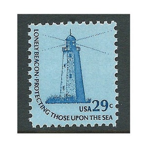 May include: A blue and white vintage postage stamp featuring a lighthouse with the text "Lonely Beacon - Protecting Those Upon The Sea" and "USA 29c".