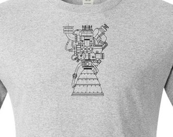 Op de afbeelding: Asgrijze t-shirt met een zwarte lijntekening van een raketmotor op de voorkant. De tekst "Ash Grey" staat onderaan het shirt. Het shirt heeft korte mouwen en een ronde hals.