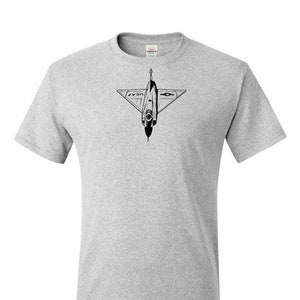 May include: Ash grey t-shirt featuring a black and white illustration of a jet aircraft. The aircraft design includes the text "USAF" and a star emblem. The shirt is a crew neck style.