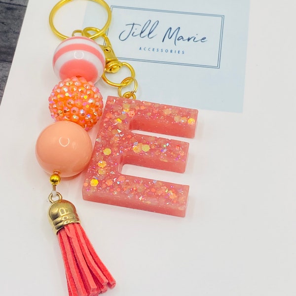 Coral bubblegum beaded keychain with custom resin initial.