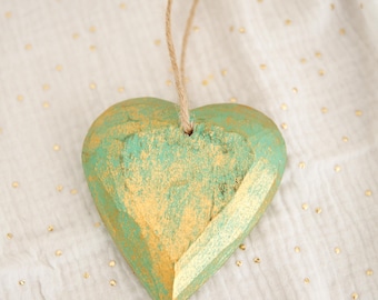 Green and gold wooden hanging heart, with natural fiber rope, handmade in Bali.