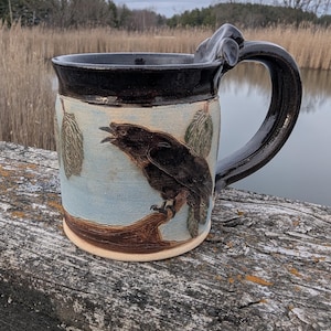 Black crow raven in a pine tree handmade stoneware pottery mug cup