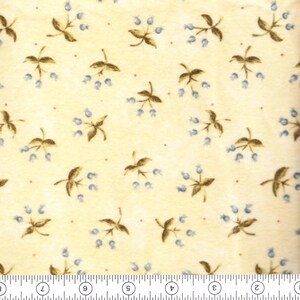 May include: Cream-colored fabric with a repeating pattern of brown leaves and small blue berries. Tiny red dots are scattered across the background. The fabric is measured in inches.