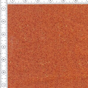 May include: A close-up of a textured, orange-brown surface with small, gold flecks throughout.