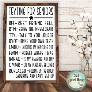 May include: A white sign with black text that reads "Texting for Seniors" and lists common texting abbreviations used by seniors. The sign is framed in wood and has a rustic look.