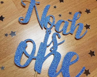 Personalised Glitter First Birthday Cake Topper: "Name is One"