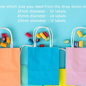 May include: Three colorful paper gift bags with white handles, filled with candy, are arranged on a blue background. The bags are orange, blue, and pink. Text at the top indicates label sizes: 37mm, 45mm, and 63mm diameter.