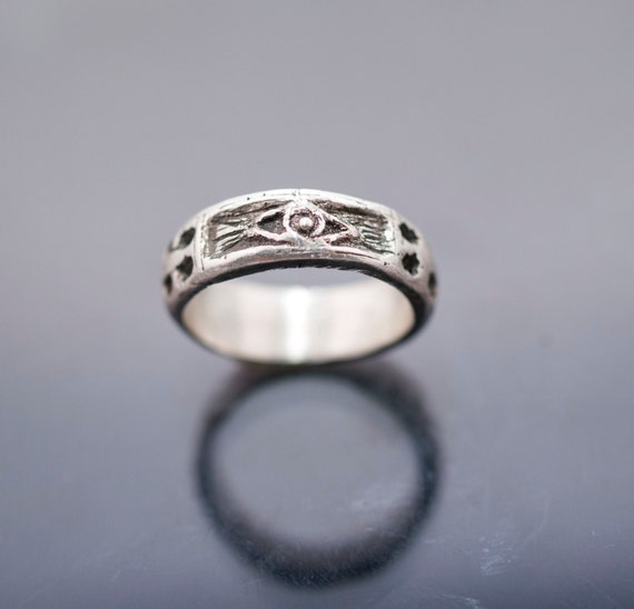 silver ring whit skulls snake cross and eye