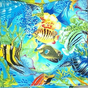 May include: A colorful fabric with a tropical fish and coral reef design. The fabric features a variety of fish, including angelfish, butterflyfish, and pufferfish, as well as coral, seaweed, and other marine life.