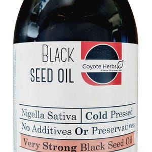 May include: A black bottle of black seed oil with a white and red label. The label reads "Black Seed Oil" and includes the text "Nigella Sativa" and "Cold Pressed". The bottle contains 500ml.
