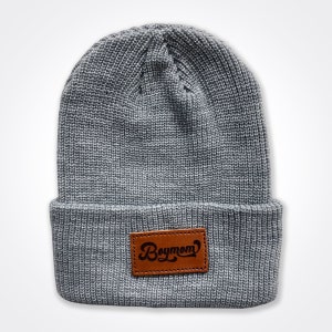 May include: Gray knitted beanie with a brown leather patch that says "Boymom" in a retro font.