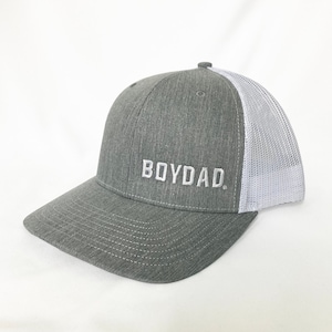 May include: A gray and white trucker hat with a white embroidered logo that says "BOYDAD."