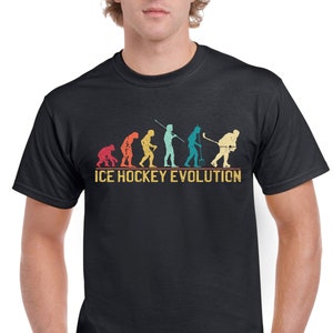 May include: A black t-shirt with a vintage-style graphic of the evolution of ice hockey. The graphic shows a series of stick figures, starting with a caveman and ending with a modern ice hockey player. The text "ICE HOCKEY EVOLUTION" is printed below the graphic.