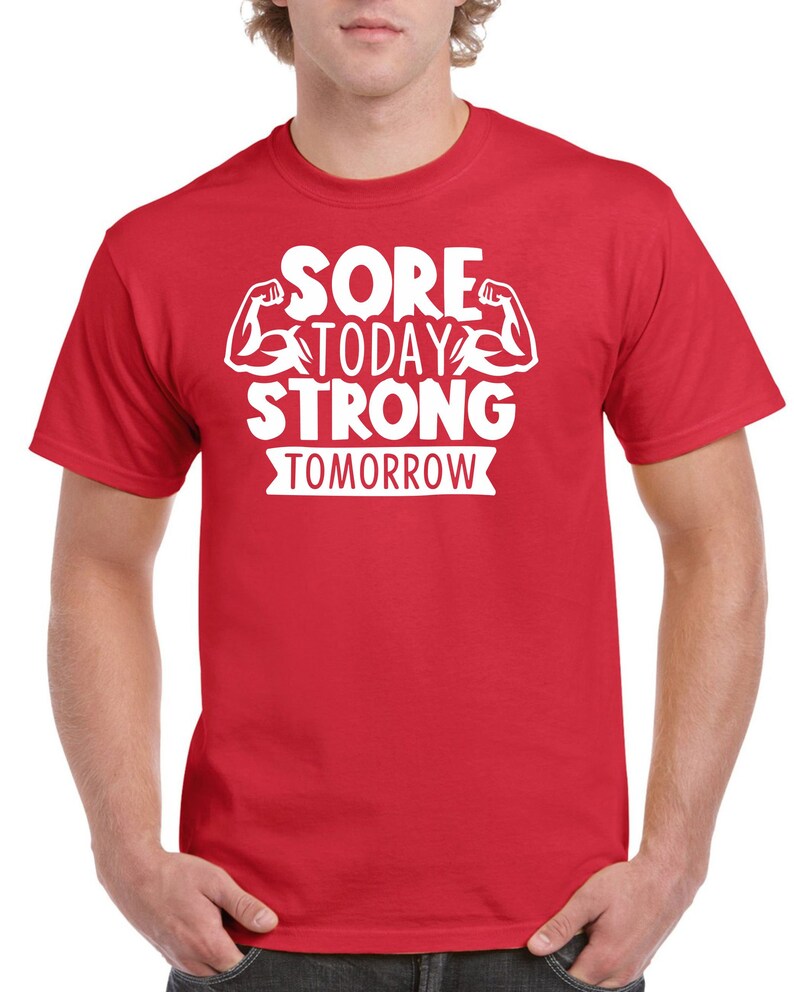 May include: Red t-shirt with white text that reads "Sore Today Strong Tomorrow" with a graphic of two white bicep muscles.