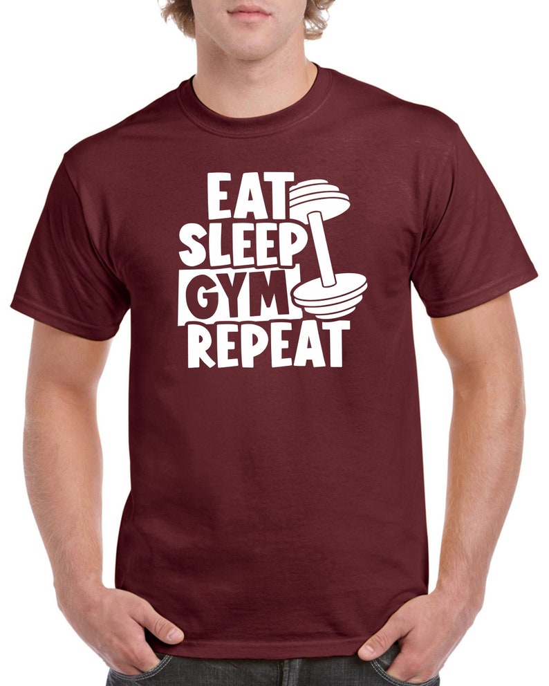 May include: Burgundy t-shirt with white text that reads "Eat Sleep Gym Repeat" and a white dumbbell graphic.