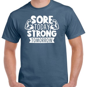 May include: A blue t-shirt with white text that reads "Sore Today Strong Tomorrow" with a graphic of two bicep muscles.