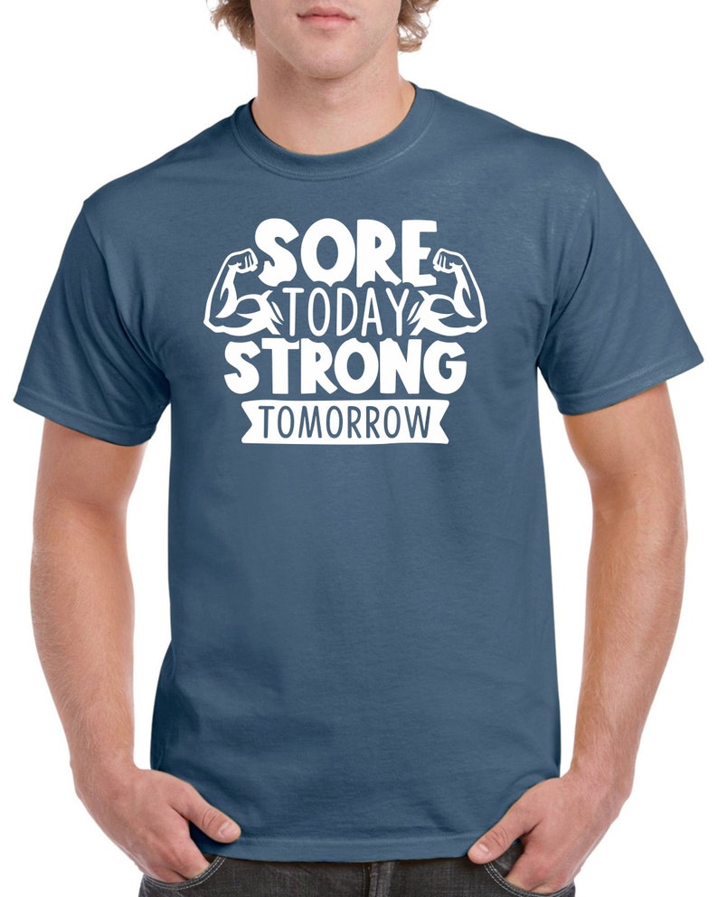 May include: A blue t-shirt with white text that reads "Sore Today Strong Tomorrow" with a graphic of two bicep muscles.