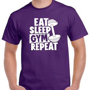 May include: Purple t-shirt with white text that reads "Eat Sleep Gym Repeat" and a white dumbbell graphic.