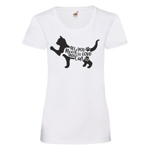 May include: White t-shirt with a black cat silhouette and the text "All you need is love and a cat" printed on the front.
