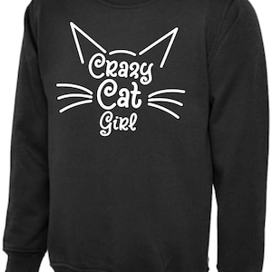 May include: Black sweatshirt with a white cat face and the text "Crazy Cat Girl" printed on the front.