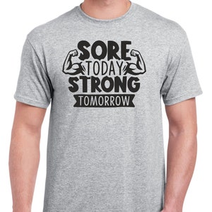 May include: A heather grey t-shirt with a black graphic that reads "Sore Today Strong Tomorrow" with two black bicep illustrations.