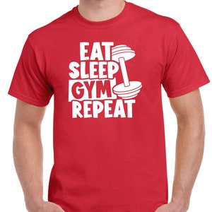 May include: Red t-shirt with white text that reads "Eat Sleep Gym Repeat" and a white dumbbell graphic.