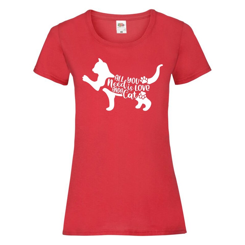 May include: Red women's t-shirt with a white silhouette of a cat and the text "All you need is love and a cat".