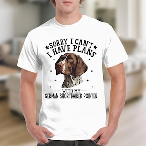 May include: White t-shirt with a brown and white German Shorthaired Pointer dog illustration. The text on the shirt reads "Sorry I can't I have plans with my German Shorthaired Pointer."