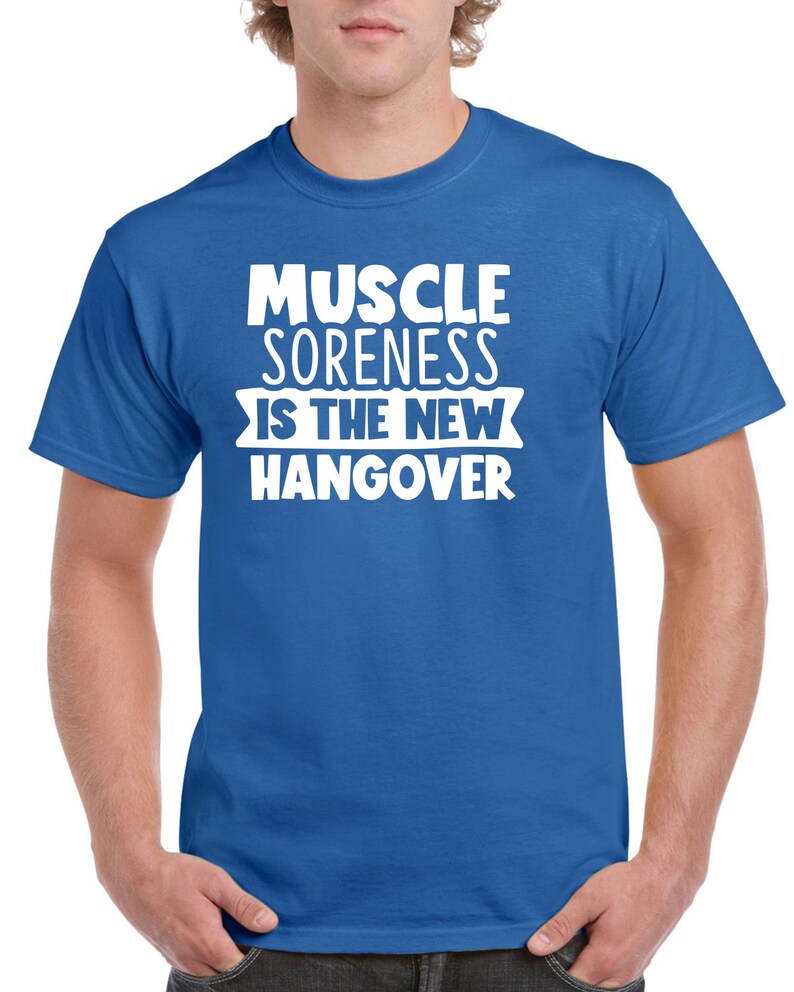 May include: A royal blue t-shirt with white text that reads "Muscle Soreness Is The New Hangover".