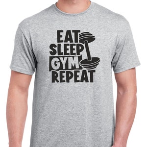 May include: Gray t-shirt with a black graphic that says "Eat Sleep Gym Repeat" with a dumbbell graphic.