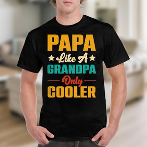 May include: Black t-shirt with a retro-style graphic that reads "PAPA Like A GRANDPA Only COOLER".