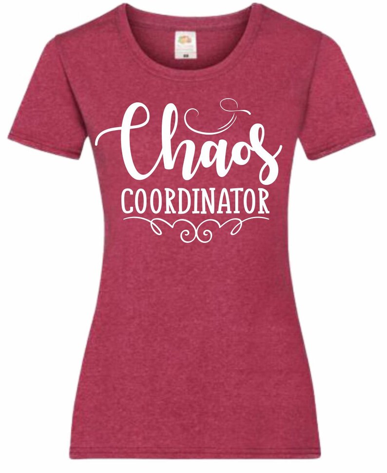 May include: A red heather t-shirt with white text that reads "Chaos Coordinator" with a decorative flourish underneath.