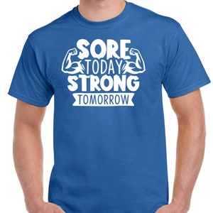 May include: A royal blue t-shirt with white text that reads "Sore Today Strong Tomorrow" with a graphic of two white bicep muscles.