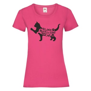 May include: Pink women's t-shirt with a black silhouette of a cat and the text "All you need is love and a cat".