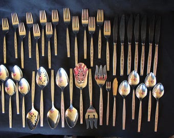 May include: A set of silver flatware with ornate handles. The set includes forks, knives, spoons, and serving utensils.