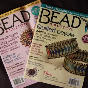 May include: Two Bead & Button magazines with light pink and cream covers. The magazines feature text including "Quilted peyote," "New designs using classic techniques," and "Stitch an easy bracelet in under 2 hours," alongside images of beaded jewelry.