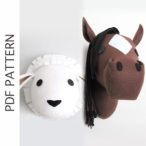 Peut inclure: Une tête de mouton en feutre blanc et une tête de cheval en feutre marron, toutes deux avec des yeux en boutons noirs. Le cheval a une crinière en feutre noir et une étoile blanche en feutre sur le front. Ce sont des patrons de tête d'animaux en feutre à faire soi-même.
