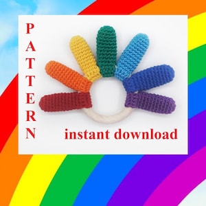 May include: A rainbow crochet teether with a wooden ring in the center. The teether has seven colorful crocheted fingers, each a different color of the rainbow. The text "PATTERN" is on the left side of the image and "instant download" is on the right side of the image.