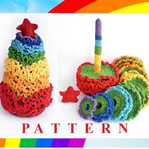 May include: Rainbow crochet stacking rings with a star on top. The rings are made in different colours, including red, orange, yellow, green, blue, and purple. The rings are stacked on top of each other, and the star is on top of the rings. The rings are made of a soft, crocheted material. PATTERN