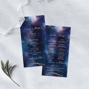 May include: Two wedding ceremony programs with a celestial design. The programs have a dark blue background with gold geometric accents and white text. The programs list the ceremony details and wedding party.