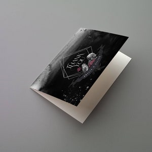 May include: A folded greeting card with a black watercolor background and the words "THANK YOU" in a geometric frame. The card features floral and owl illustrations with a banner that reads "Amelia & Victor".