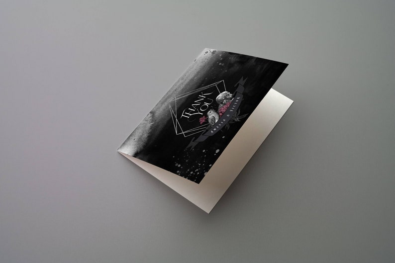 May include: A folded greeting card with a black watercolor background and the words "THANK YOU" in a geometric frame. The card features floral and owl illustrations with a banner that reads "Amelia & Victor".