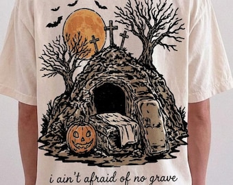 Non ho paura di nessuna tomba PNG, maglietta cristiana di Halloween, grafica della resurrezione, zucca del cimitero, design spettrale di fede