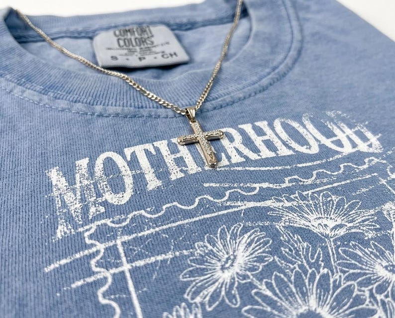Christian motherhood graphic for boutique apparel featuring vintage floral line art and retro texture