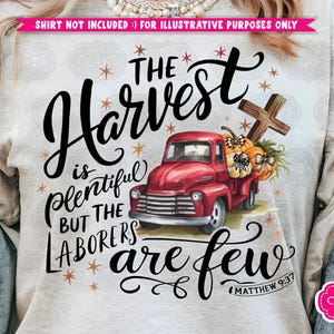 May include: A white t-shirt with a red truck carrying pumpkins and a cross. The text on the shirt reads "The Harvest is Plentiful But The Laborers Are Few" with the scripture reference "Matthew 9:37".