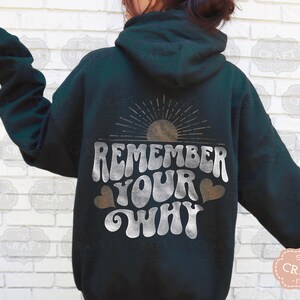 May include: A dark green hoodie with a white graphic that says "Remember Your Why" with a sun and hearts.