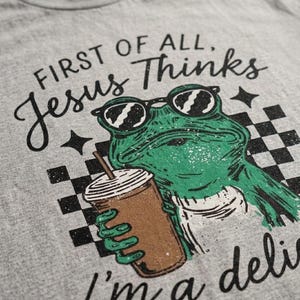 Funny faith based PNG featuring green frog illustration and checkerboard pattern details.